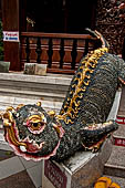 Chiang Mai - Wat Phra That Doi Suthep. The entrance of the vihan dedicated to King Kuena is guarded by Mom, aquatic mythical creatures. 